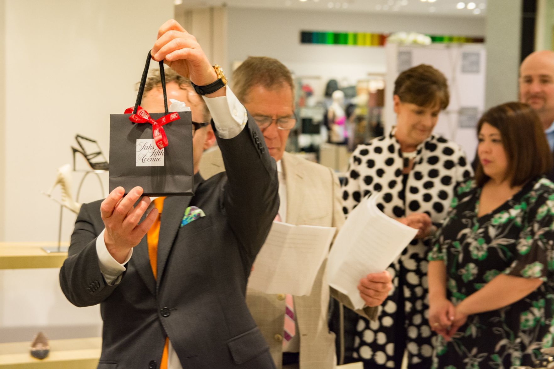 Collier Maxwell holds up the gift bag for attendees of the event
